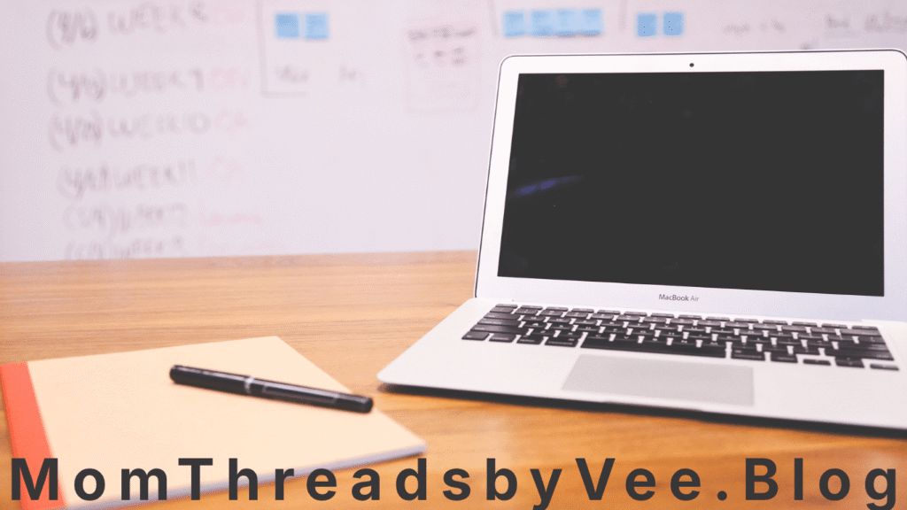 Affordable laptop on a study desk with notebooks and school supplies for student schoolwork.