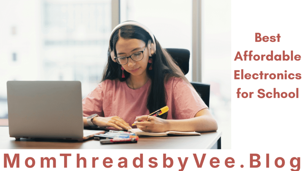 A girl using a laptop, a headphone and some writing essentials