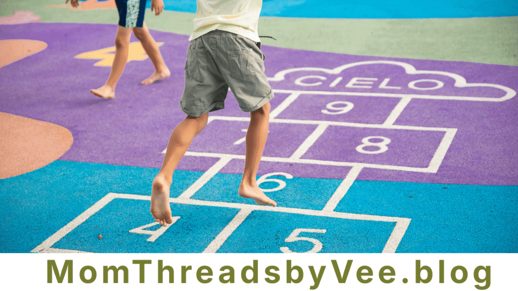 Kids playing hopscotch outside as a fun screen-free activity